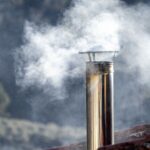 A row of Manchester homes with visible chimneys on a cold winter day, symbolizing the importance of timely boiler repairs to keep households warm and safe