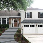 Modern UK home with a newly installed classic carriage-style garage door, blending traditional charm with contemporary design
