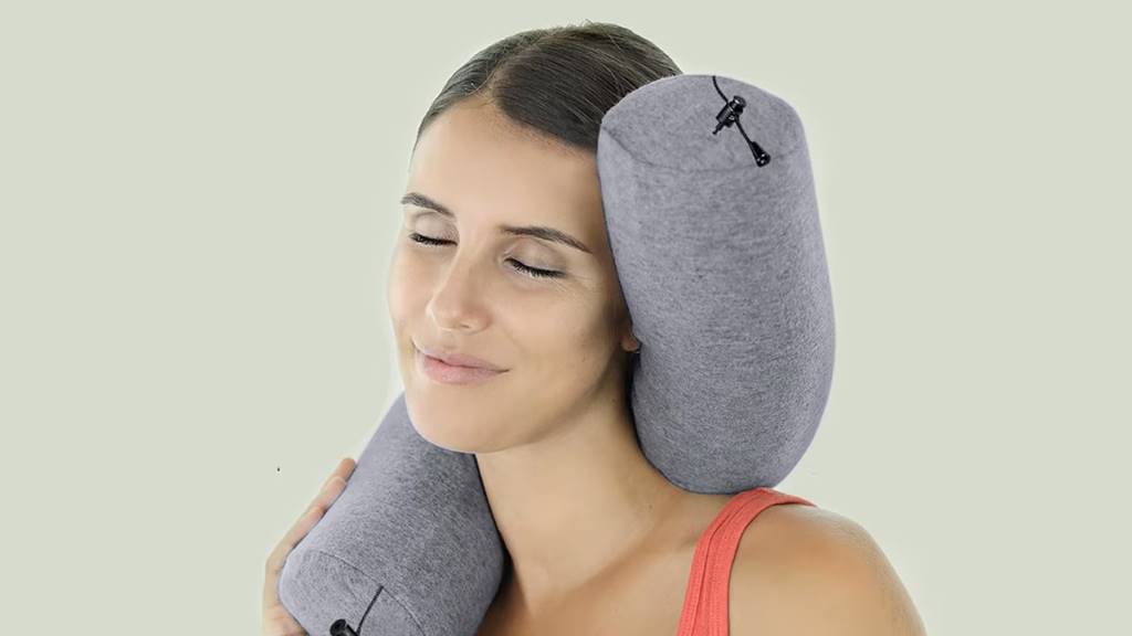 Packed Dot&Dot Twist pillow in compact drawstring bag next to passport for size comparison