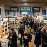 Shoppers browsing handmade jewelry, ceramics, and gourmet gifts at the One of a Kind Holiday Show 2026 on the 7th floor of the Merchandise Mart in Chicago